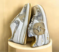 Nike ergonomic training shoes with decorative Louis Vuitton patterns, offering a stylish fusion of sportswear and luxury.